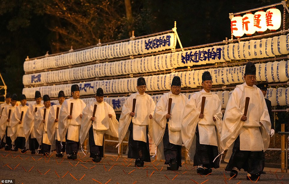 JAPAN: Shintoist priests walk past paper lanterns after concluding a ritual in preparation for the New Year at Meiji Shrine in Tokyo