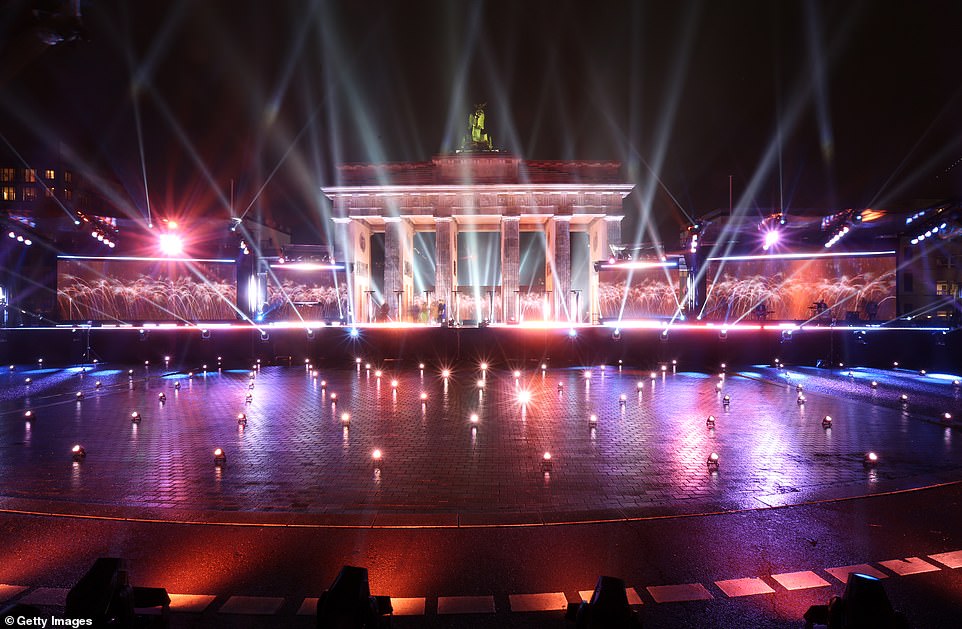 The Brandenburg Gate in Berlin was lit up on the stroke of midnight to usher in the New Year, however, revellers were not allowed to watch the festivities in person