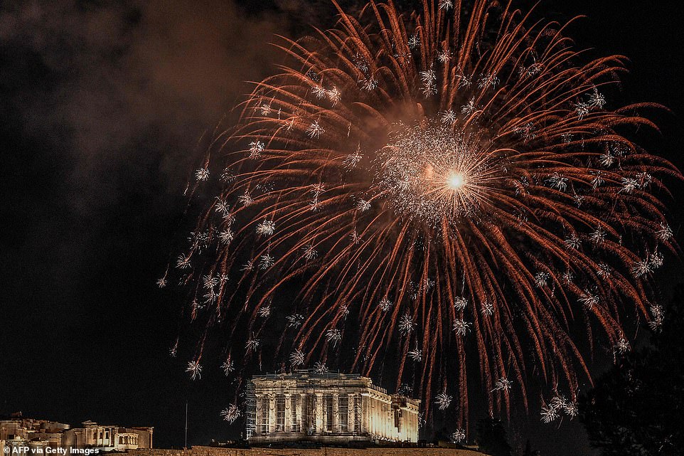 Fireworks explode over the Acropolis in Athens, Greece, during the New Year's Eve celebrations