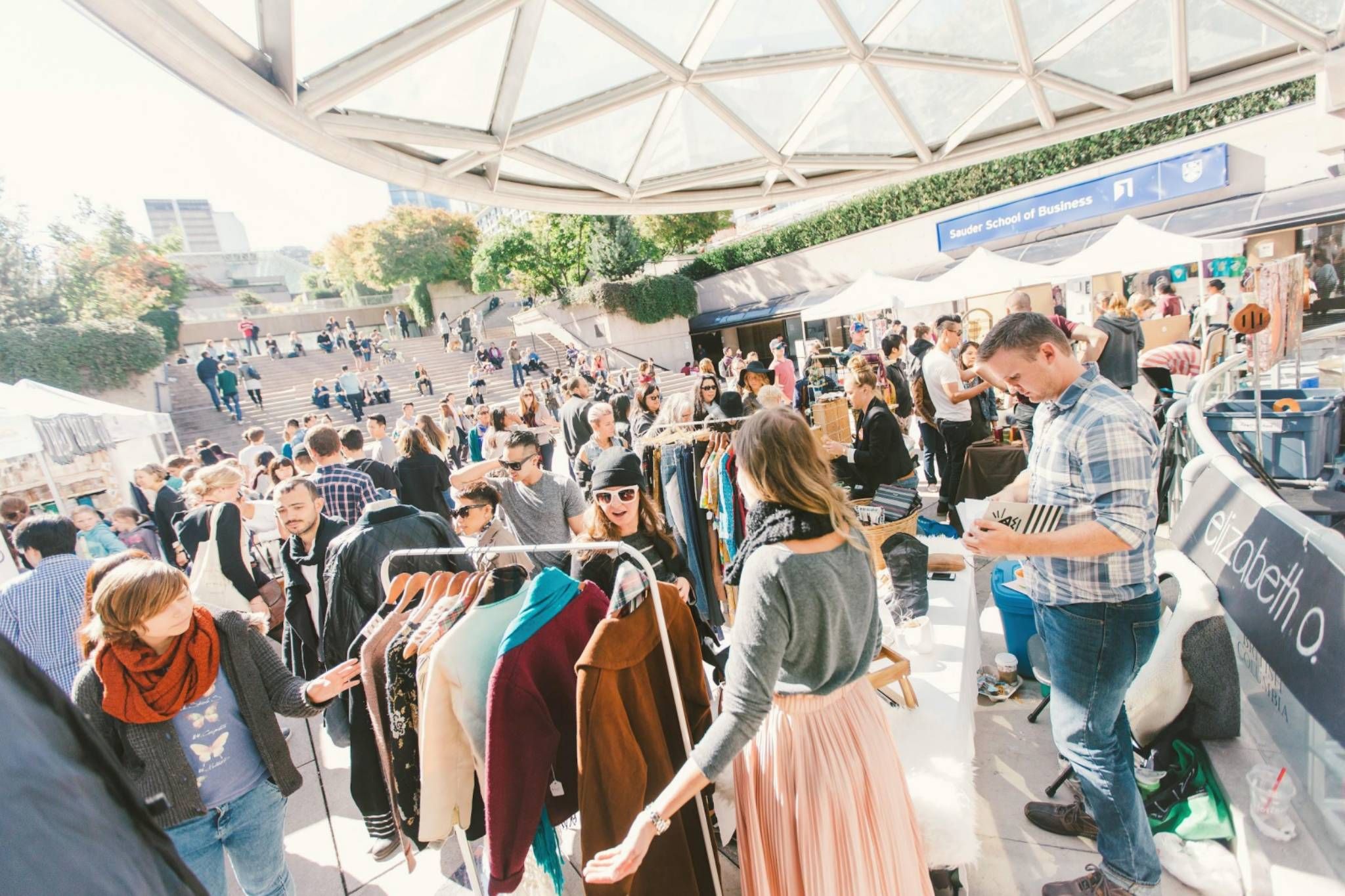 People shop at an outdoor market.